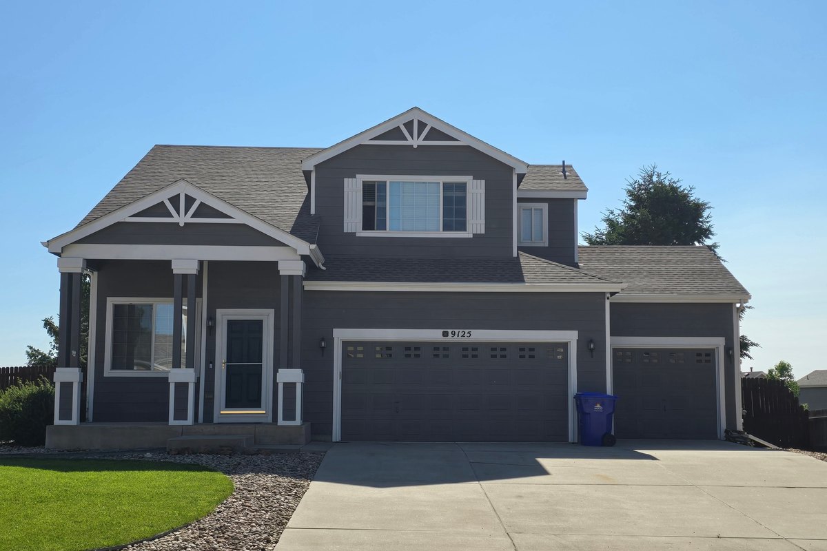 Two-story house with gray lap siding and white trim