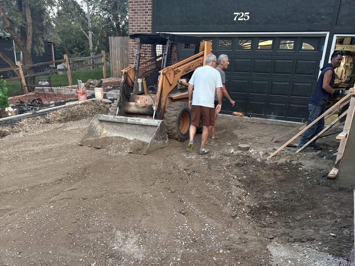 Crew grading and leveling a yard ahead of a concrete pour