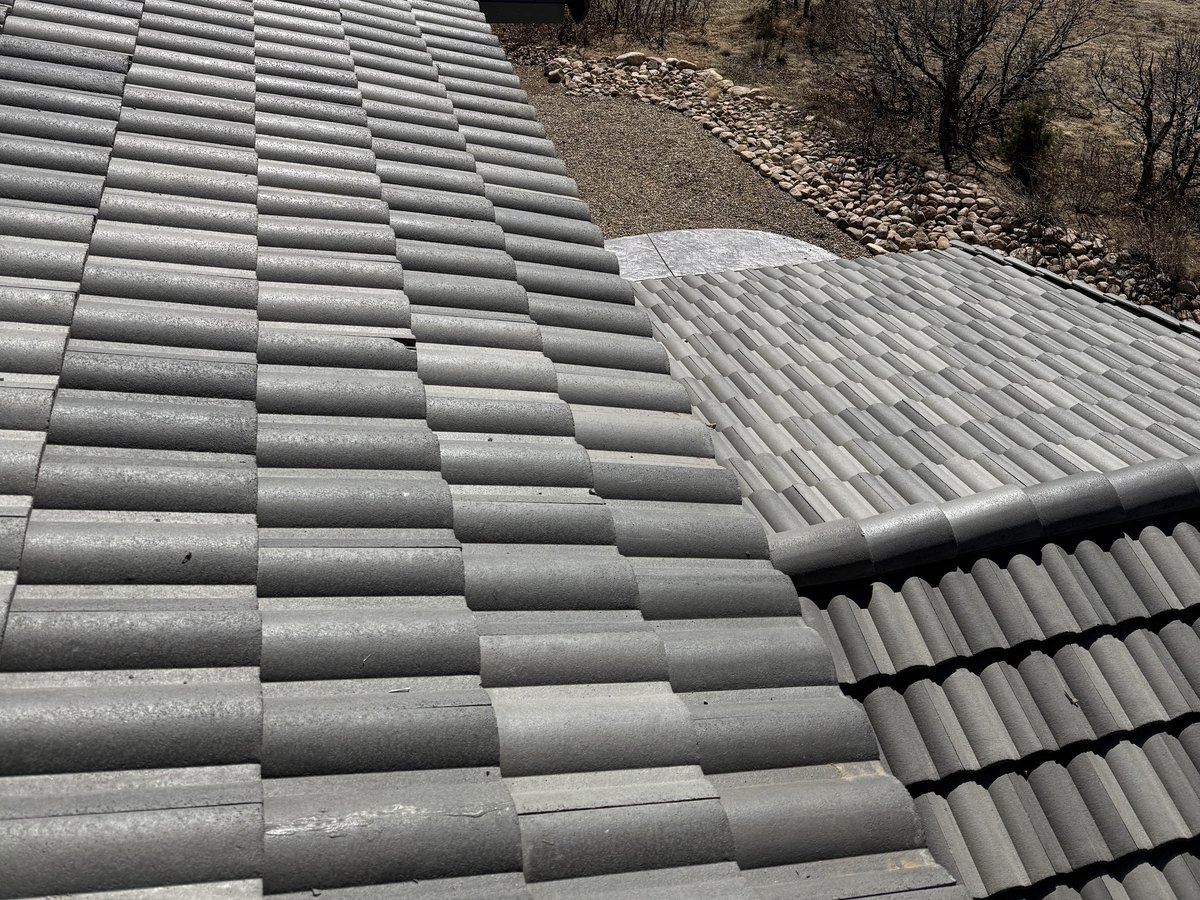 Gray tile roof running across several valleys and ridges