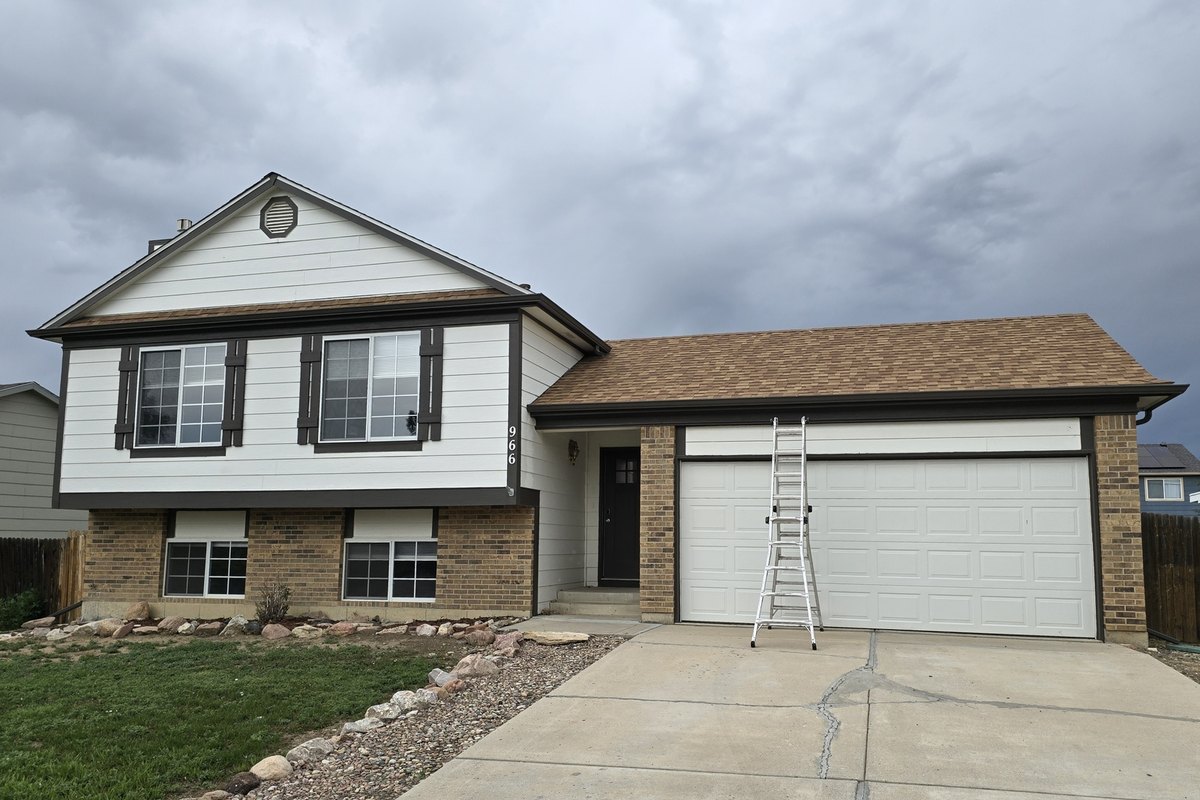 Split-level house with gutters and downspouts along the front eaves