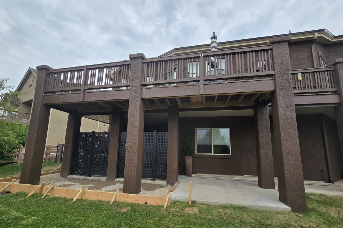 Newly built raised deck over a covered patio at the rear of a house