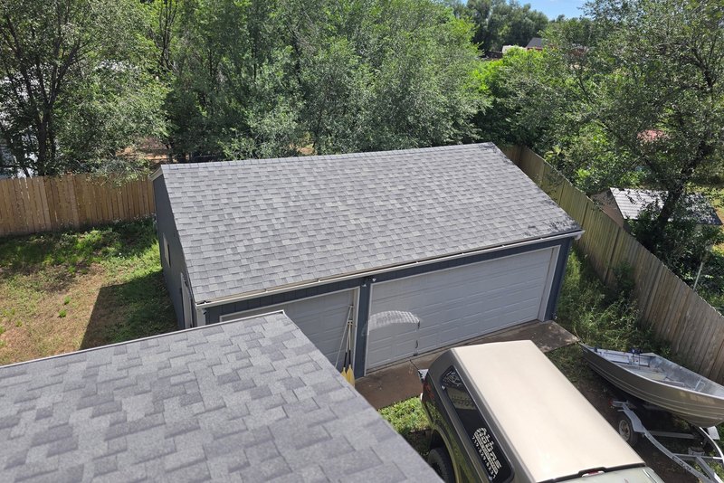 Sound gray shingle roof above a garage with clean flashing details
